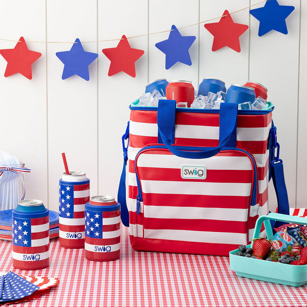Swig Life All American Insulated Boxxi 24 Cooler Backpack on a patriotic red white and blue table setting