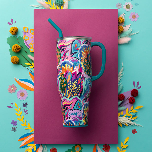 Swig Life Insulated Bazaar 40oz Mega Mug on a pink background surrounded by colorful plants