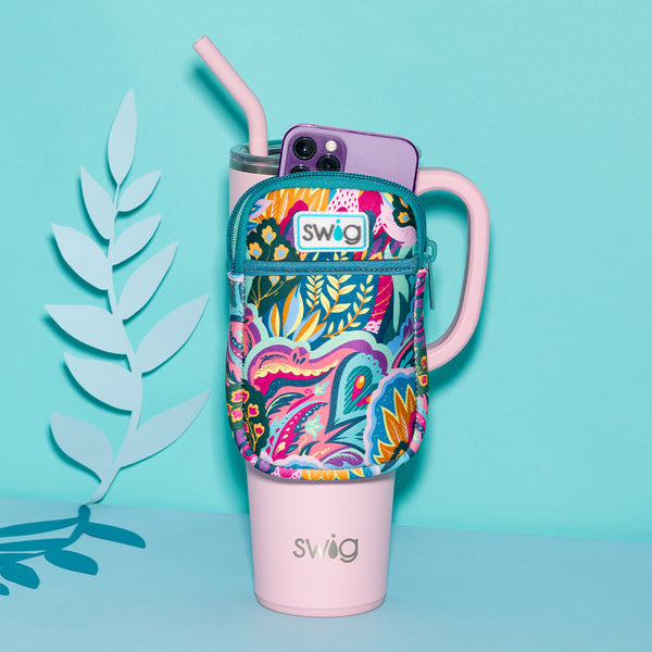 Swig Life Bazaar Mega Mug Pouch holding a phone, strapped onto a 40oz Blush Mega Mug on a blue background