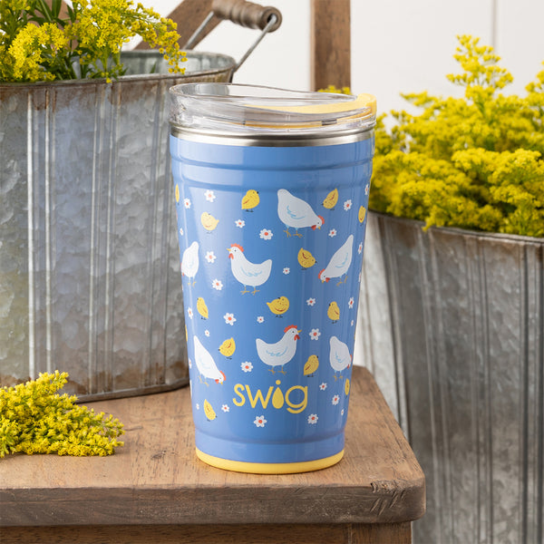 Swig Life 24oz Chicks Dig It Insulated Party Cup outside in a garden