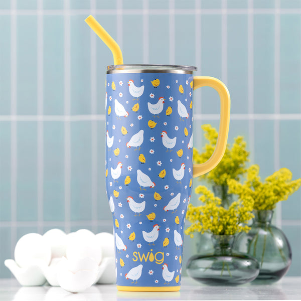 Swig Life Insulated Chicks Dig It 40oz Mega Mug on a blue tile background next a carton of eggs