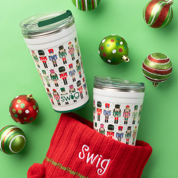 Swig Life 24oz Classic Nutcracker Insulated Party Cup on a green holiday background surrounded by ornaments