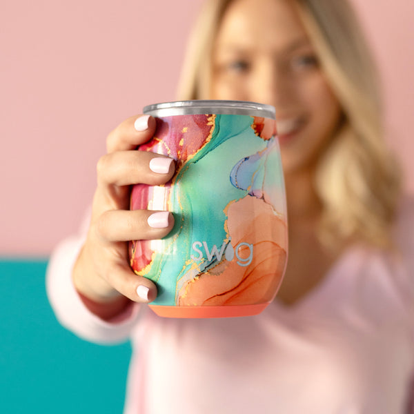 Swig Life 14oz Dreamsicle Insulated Stemless Wine Cup held by a woman in a pink sweater