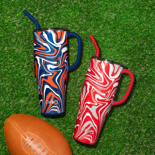 Swig Life Fanzone Navy + Orange and Fanzone Red + Grey 40oz Mega Mugs on a green grassy background