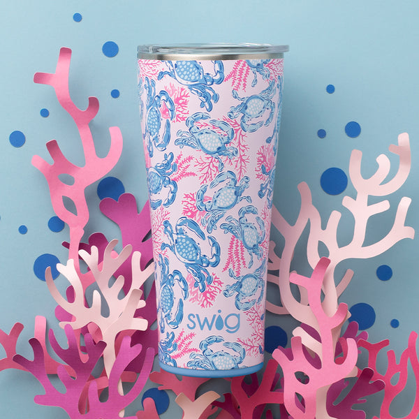 Swig Life 32oz Get Crackin' Insulated Tumbler on a blue background with pink coral