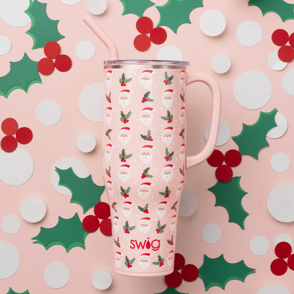 Swig Life 40oz Holly Jolly Insulated Mega Mug on a pink background with paper mistletoe