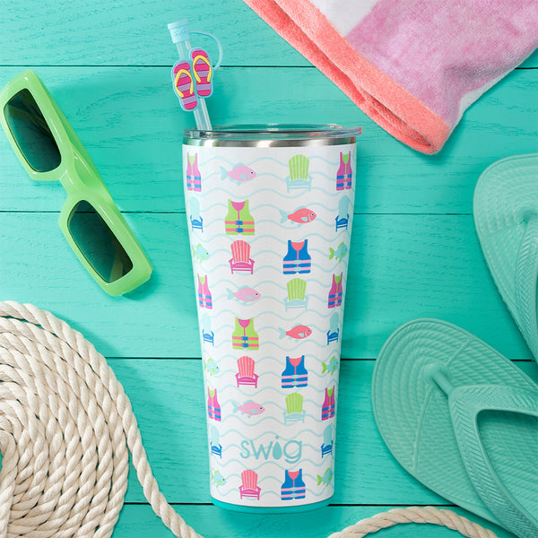 Swig Life 32oz Lake Girl Insulated Tumbler on a wooden dock surrounded by summertime accessories