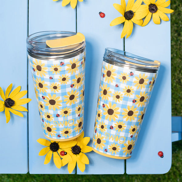 Swig Life 24oz Picnic Basket Insulated Party Cup on a blue table with yellow flowers and lady bugs