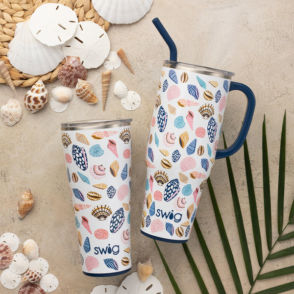 Swig Life Sea La Vie 40oz Mega Mug and 32oz Tumbler on a sandy beach background with sea shells