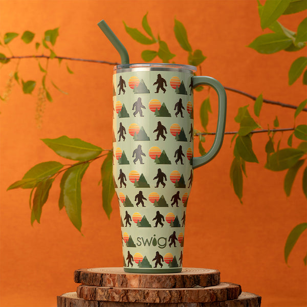 Swig Life 40oz Wild Thing Insulated Mega Mug on an orange background with plants